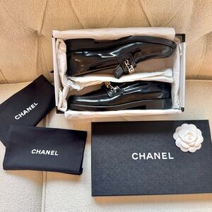 CHANEL Patent Black Loafers with Silver Accent Logo
